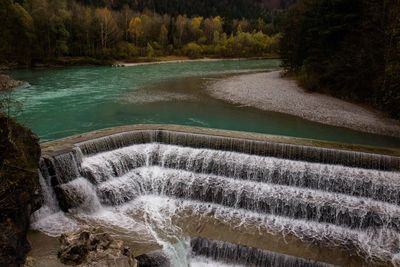 High angle view of dam by river in forest