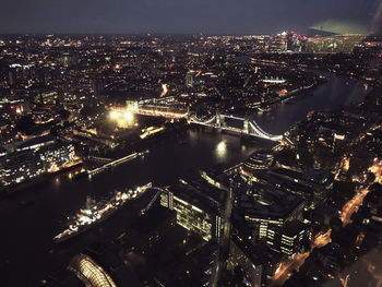 High angle view of illuminated buildings in city at night