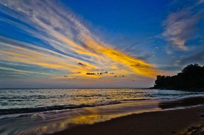 Scenic view of beach against sky during sunset