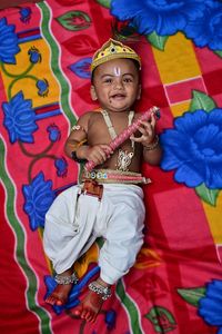 Portrait of cute baby boy on bed