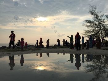 People in water at sunset
