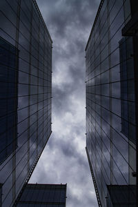 Low angle view of glass building against sky