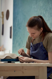 Young woman working in workshop