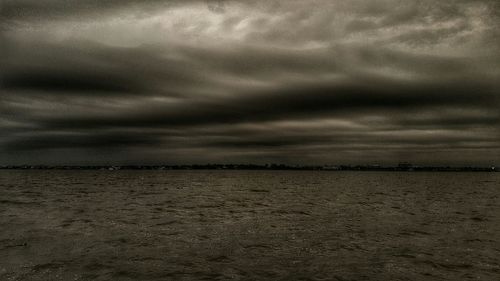 Scenic view of sea against cloudy sky