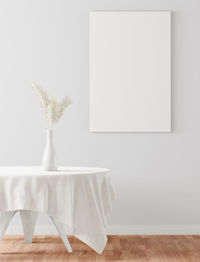 White flower vase on table at home