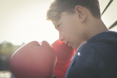 Close-up of boy wearing boxing gloves