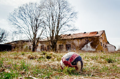 Abandoned house on field against sky