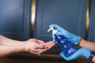 Close-up of woman holding hands and use alcohol gel 