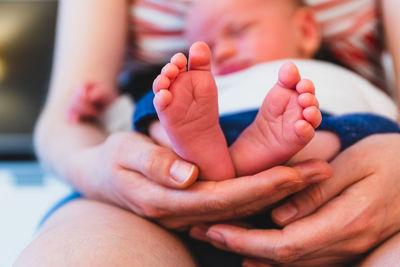 Midsection of mother holding baby