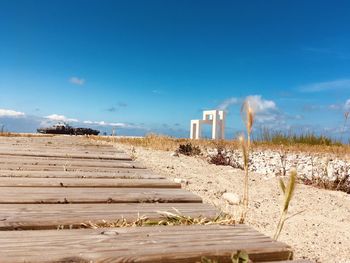 Scenic view of beach against blue sky