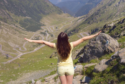 Rear view of woman standing on mountain