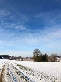 Snow covered field against sky