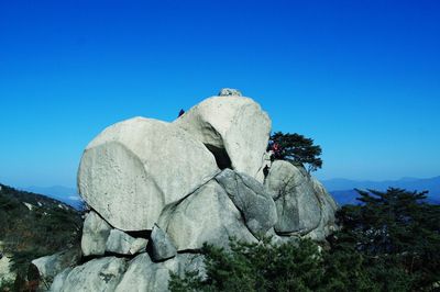 Low angle view of bird sculpture against clear blue sky