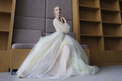 A charming ballerina went to the library to choose a new book during a break