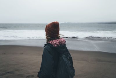 Mid adult woman standing at beach