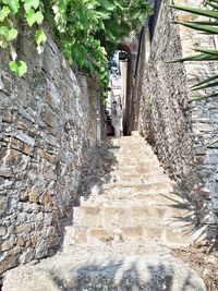 Low angle view of narrow alley amidst buildings