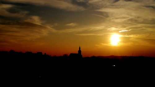 Silhouette of statue at sunset