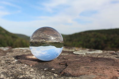 Close-up of crystal ball on land
