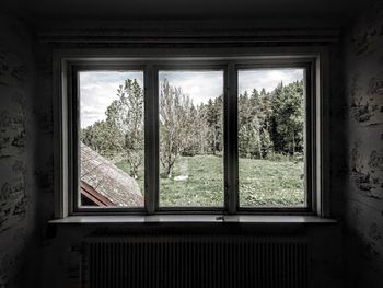 View of abandoned building through window