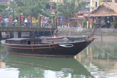 Boats moored in canal along buildings