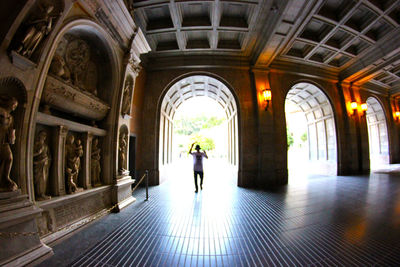 Full length of woman walking in tunnel