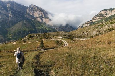 Rear view of women on landscape against mountains