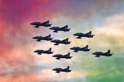 Tricolor arrow, in formation, pass trough the colored smoke