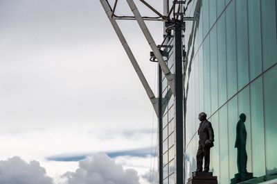 Low angle view of men against sky