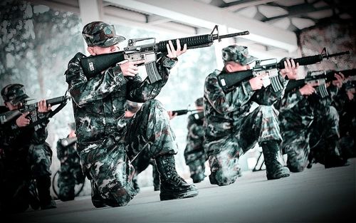 Army soldiers aiming with rifle