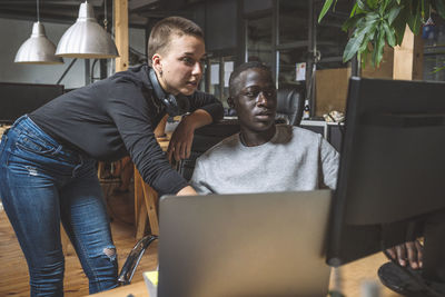 Computer programmers working on computer at workplace