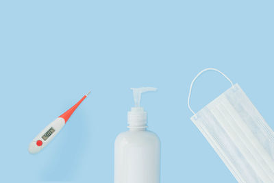 Close-up of white bottle against blue background