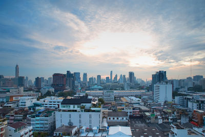 High angle view of cityscape against cloudy sky