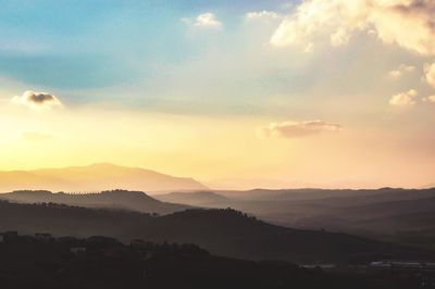 Scenic view of silhouette mountains against sky during sunset