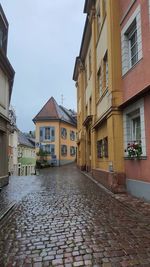 Footpath amidst buildings in town