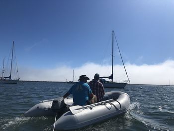Sailboat sailing on sea against sky