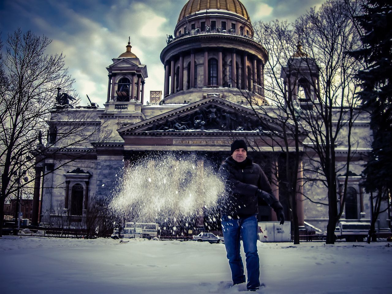 winter, architecture, built structure, looking at camera, travel destinations, city, travel, building exterior, snow, tourism, warm clothing, motion, portrait, one woman only, adults only, one person, business finance and industry, only women, outdoors, smiling, happiness, young adult, people, snowing, adult, cold temperature, young women, one young woman only, sky, day