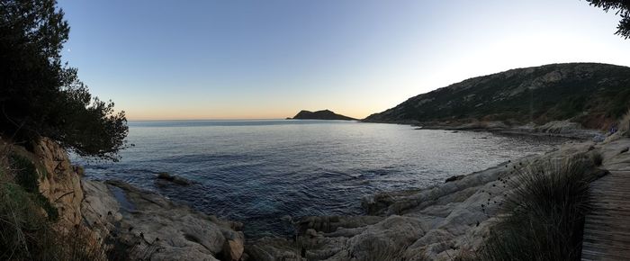 Scenic view of sea against clear sky during sunset