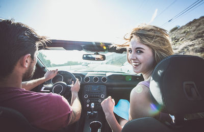 Rear view of couple sitting in car