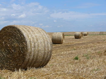 Hay bales against sky