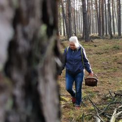 Full length of man walking in forest