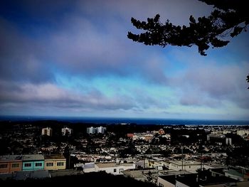 Cityscape against cloudy sky