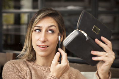 Portrait of young woman using mobile phone