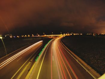 High angle view of light trails on highway at night