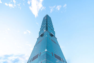 Low angle view of modern building against cloudy sky