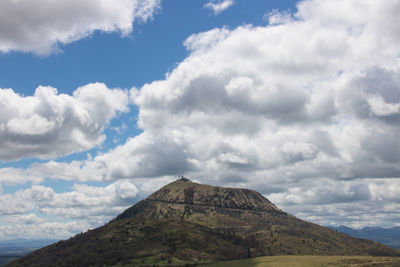 Low angle view of mountain against cloudy sky