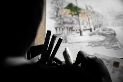 Close-up of hand holding text on table