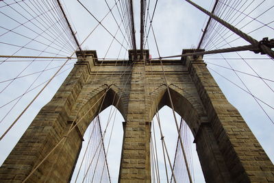 Low angle view of suspension bridge against sky