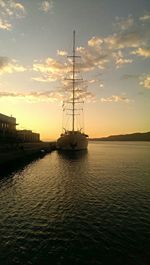 Sailboat in sea at sunset