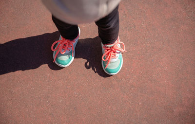 Low section of woman standing on street
