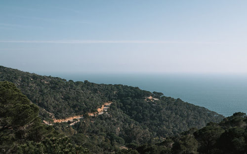 Scenic view of sea and mountains against sky